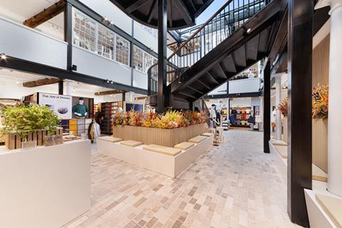 Interior of Uniqlo Covent Garden store showing staircase and products